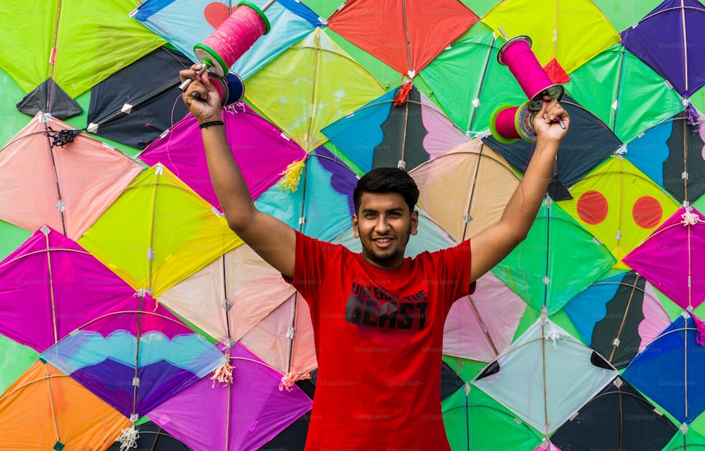 Young man with firki and pipuda for Makar Sankranti festival of India. Makar Sankranti is kite festival of India. It is also known as uttarayan