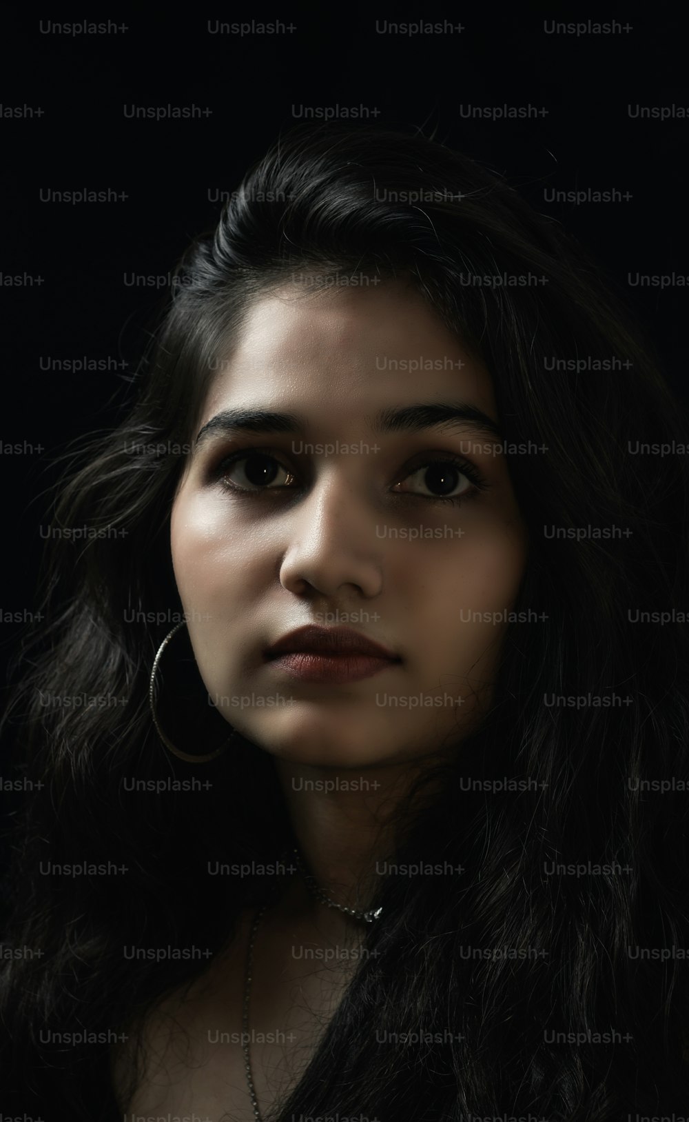 Woman in black. low key portrait of  beautiful Indian girl