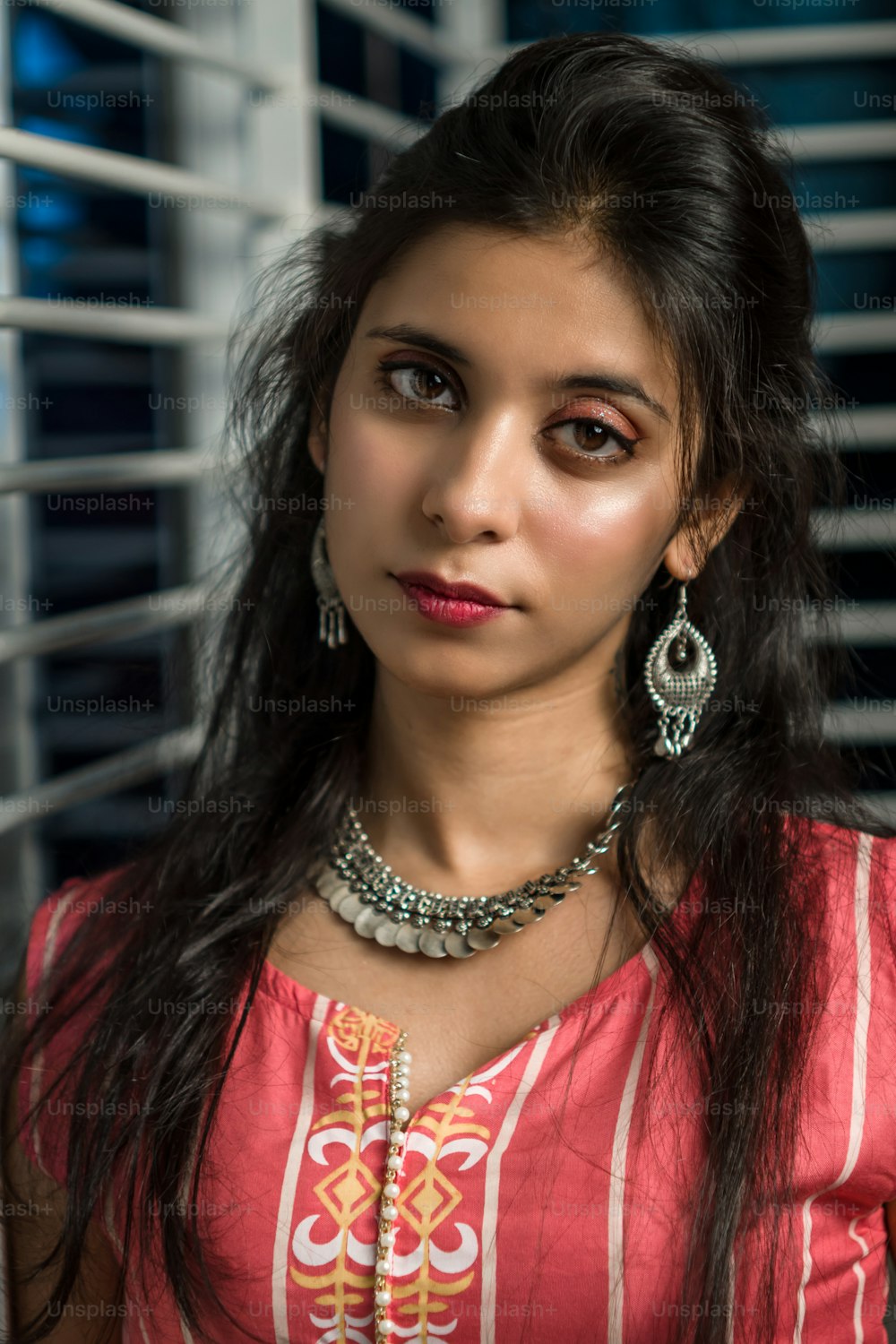 Portrait of hot indian woman with fashionable hairstyle poses. Woman posing in front of camera