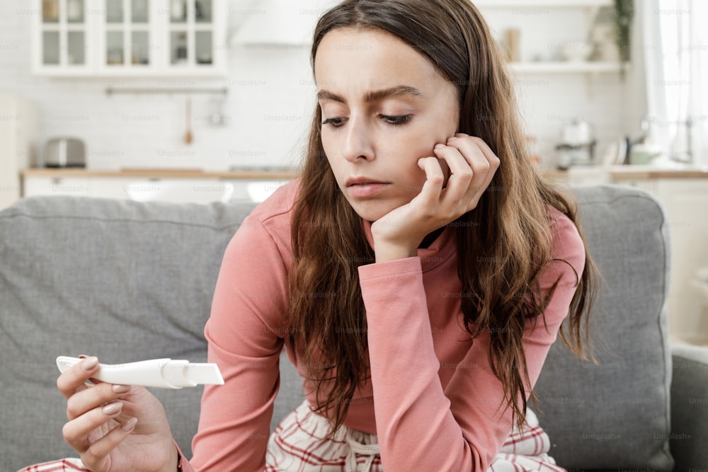 Young lady displeased with results of pregnancy test she has done alone