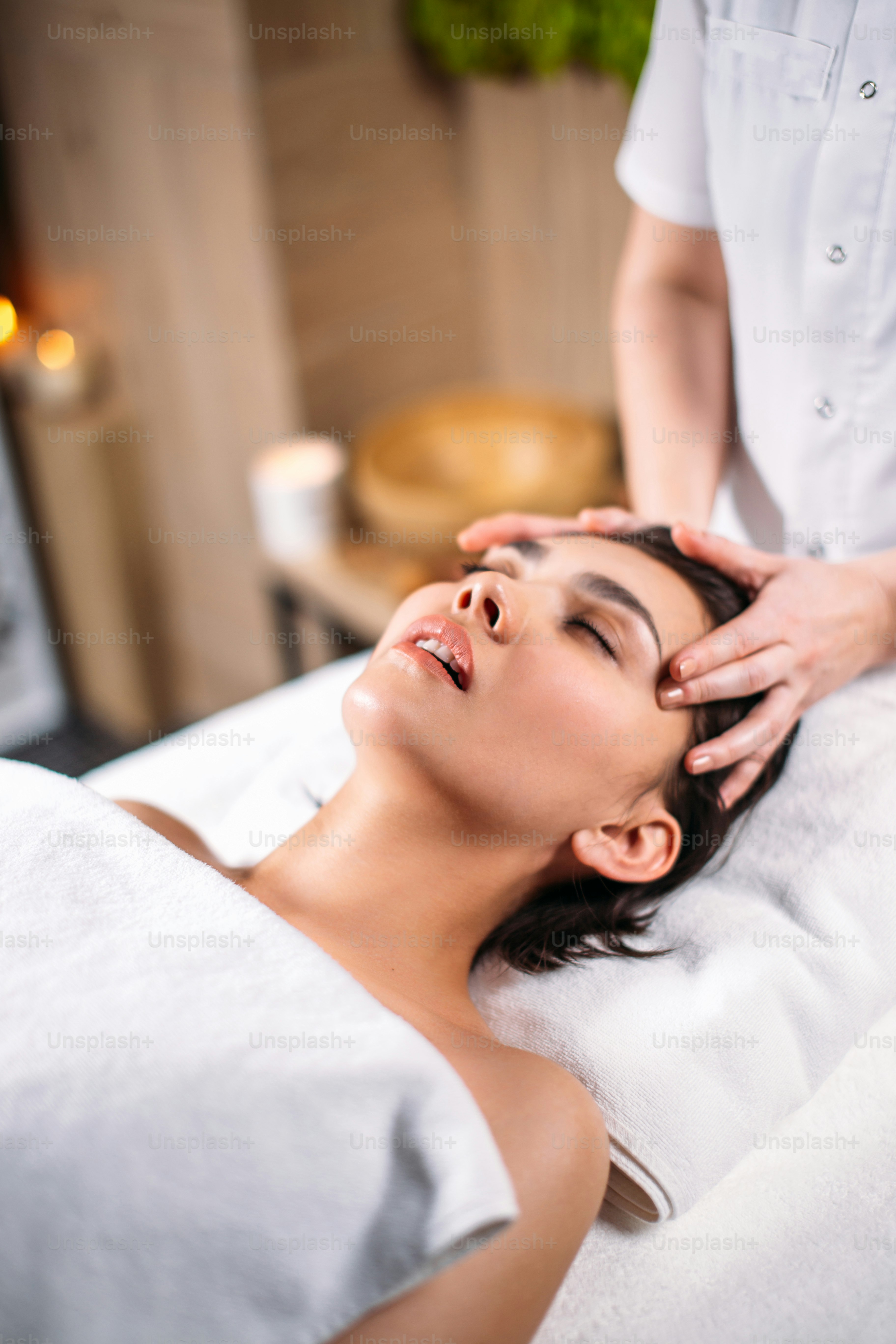 head massage service. young beautiful woman testing new method of head massage