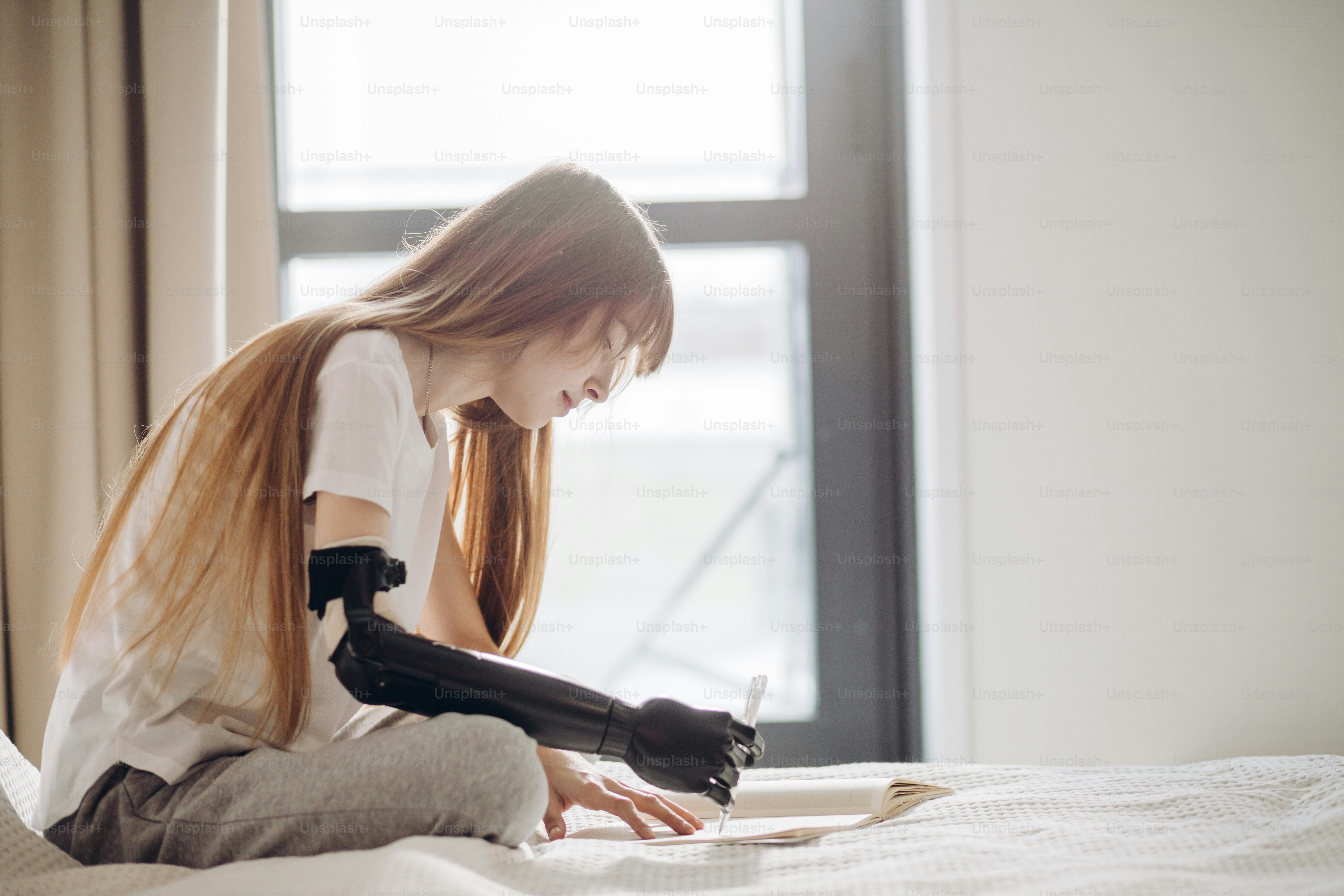 Progress in writing, woman uses prosthetic device in writing. close up ...