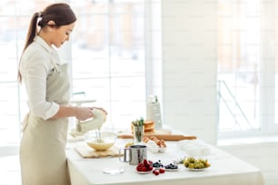 hardworking female cook at workplace, close up side vieww photo. copy space