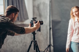 young man concentrated on making a photo at workplace. side view photo. occupation