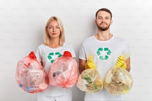 young ambitious people taking care of environment. close up portrait, global problem, isolated white background, good tradition.the solution to this pollution problem