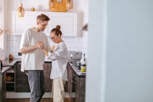 young caucasian married couple in love, dance in kitchen. love, happy relationships concept. couple in domestic clothes feel each other in every movement