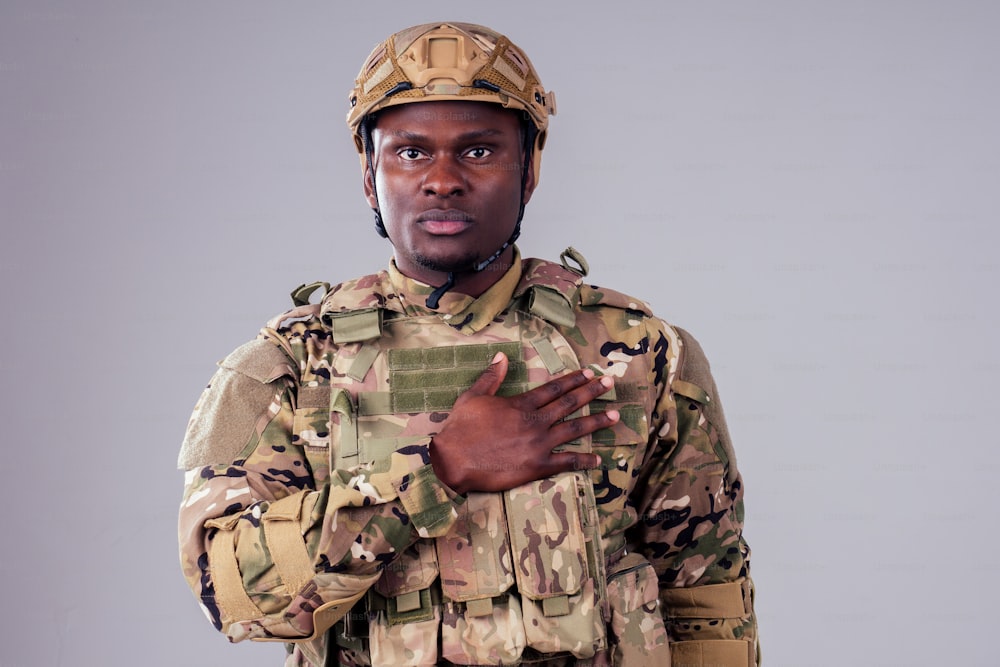 African american soldier with folded arms standing in white studio