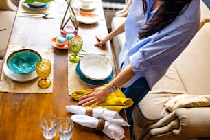 designer etiquette teacher showing how correct set a dishes in a restaurant.