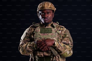 African american soldier with folded arms standing in white studio