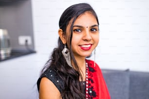 Beautiful Indian woman in traditional sari dress looking at camera bindi on the forehead .