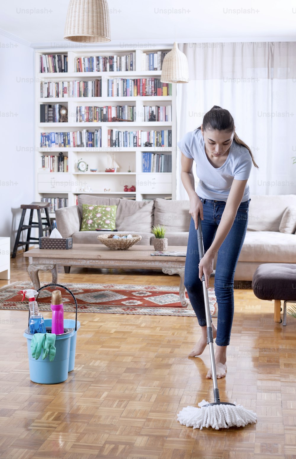 woman cleaning room of apartment