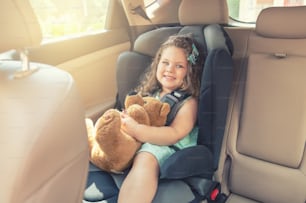 Lindo niño pequeño sentado en el asiento del automóvil. Retrato de un lindo niño pequeño sentado en el asiento del automóvil. Concepto de seguridad
