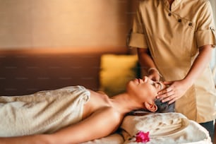 Happiness on woman's face having relaxing thai massage.