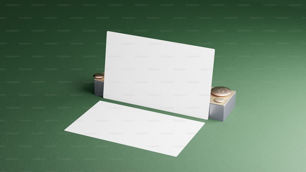 a blank card and a stamp on a green surface