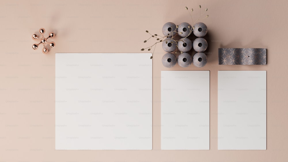 three blank paper on a table with a vase of flowers