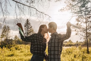 Happy girl and boy kiss and takes off protective medical mask from faces outdoors. Victory over coronavirus. The end of COVID-19 Pandemic crisis and lockdown. Happiness and hope, stop virus spreading.