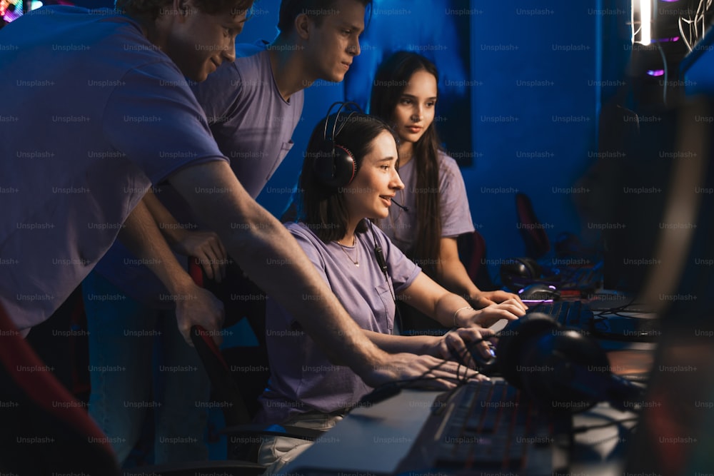 Professional e sports players at an online game tournament. The cyber team playing computers and training emotionally while looking at the screen