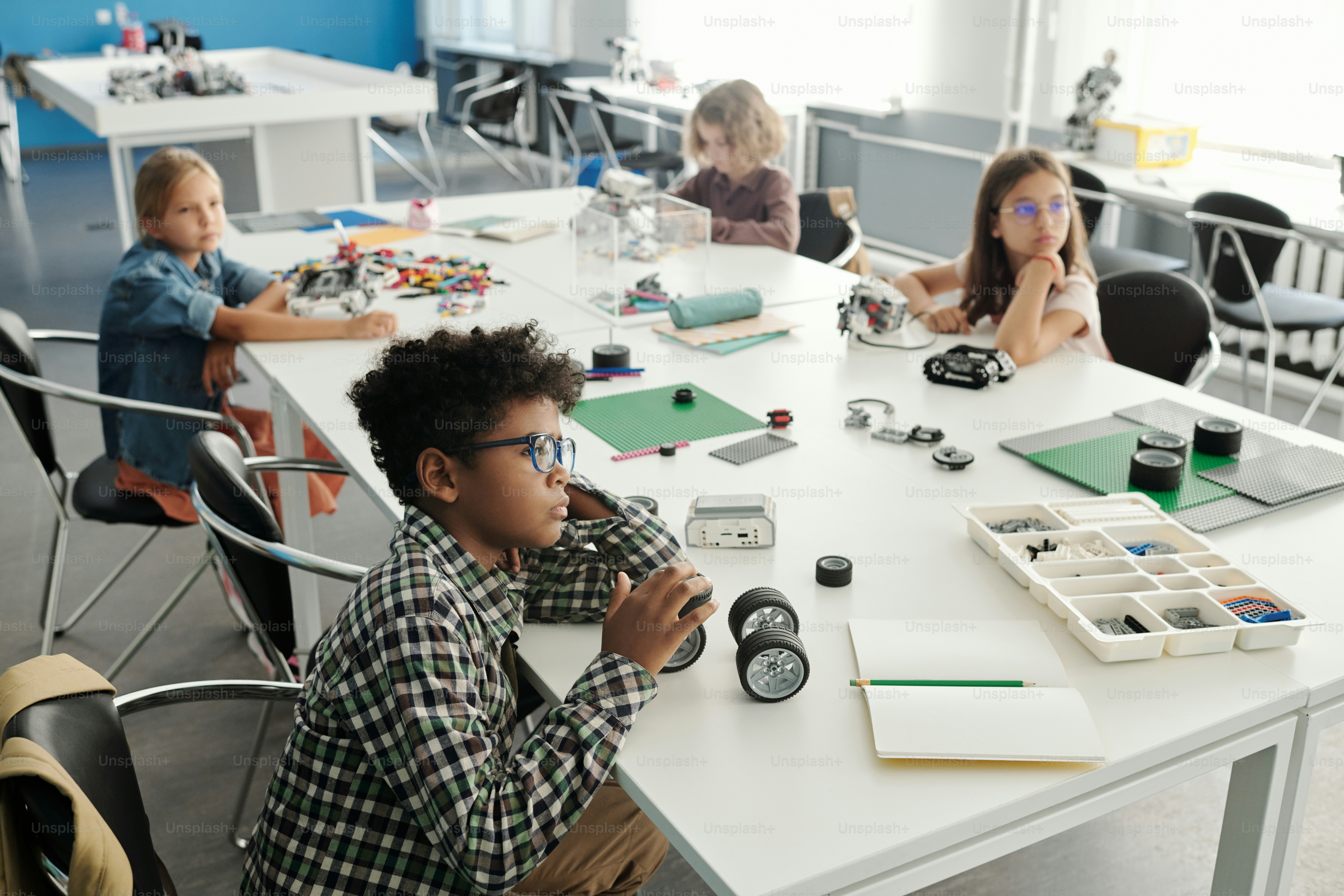 Children collaborating on a coding project in a classroom