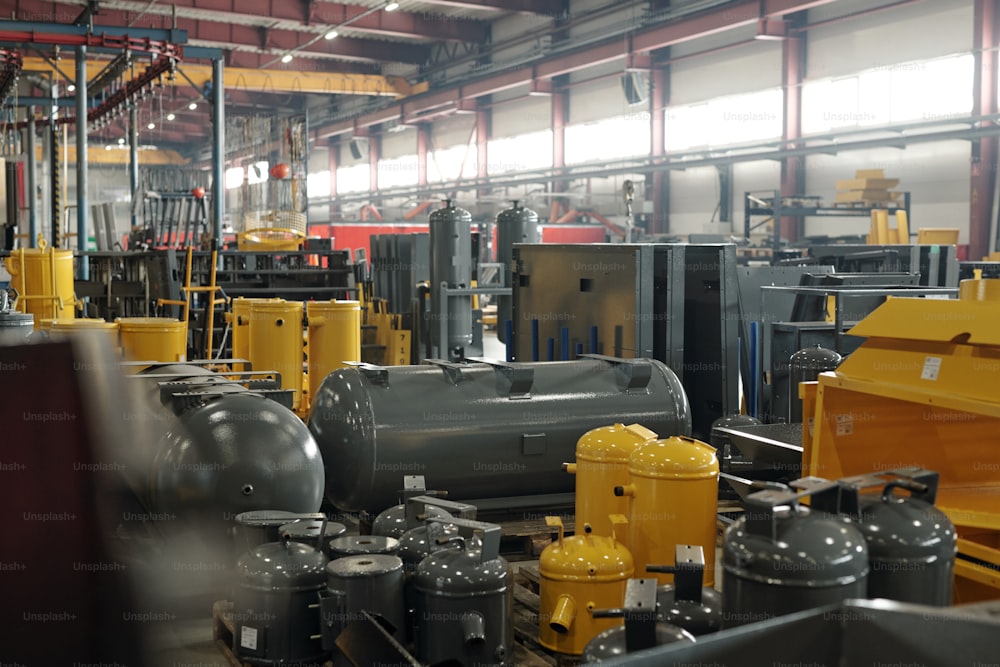 Interior of large workshop or warehouse of contemporary factory or industrial plant with new equipment of grey and yellow colors