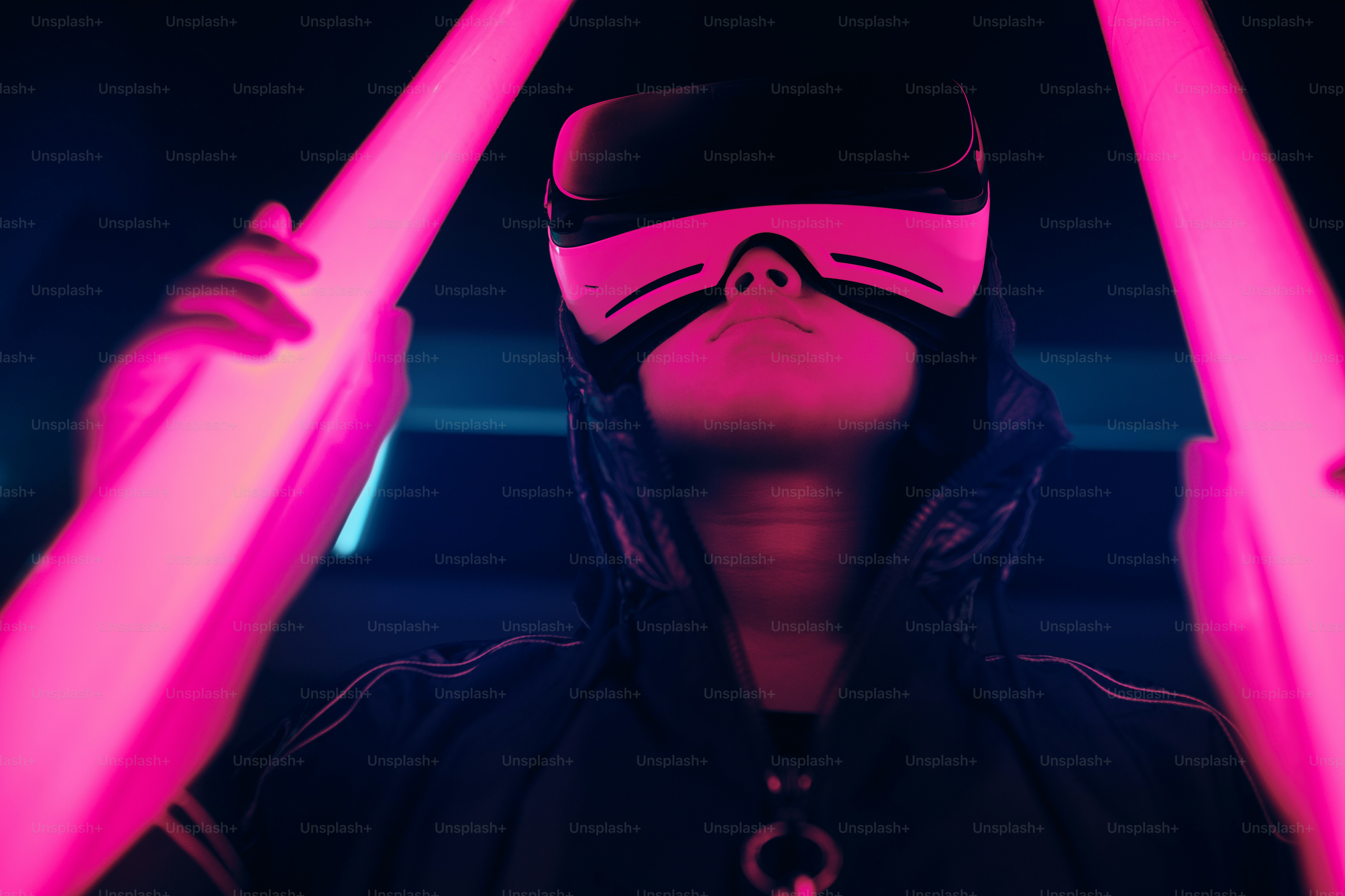 Portrait of young girl wearing Virtual Reality goggles. She is surrounded with neon light. Virtual Reality Point of View concept