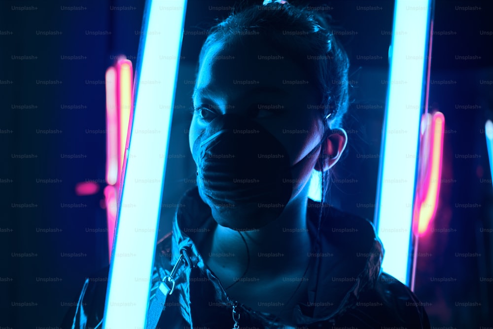 Futuristic portrait of fashionable asian girl teenager generation z, wearing face mask, protecting from virus in neon light