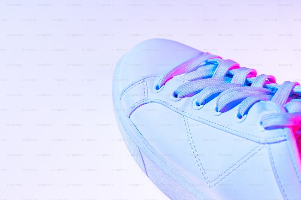 Closeup female sports shoes, sneakers isolated over neoned background. Urban city fashion, fitness, training concept. Mockup. Copy space for ad, text, design