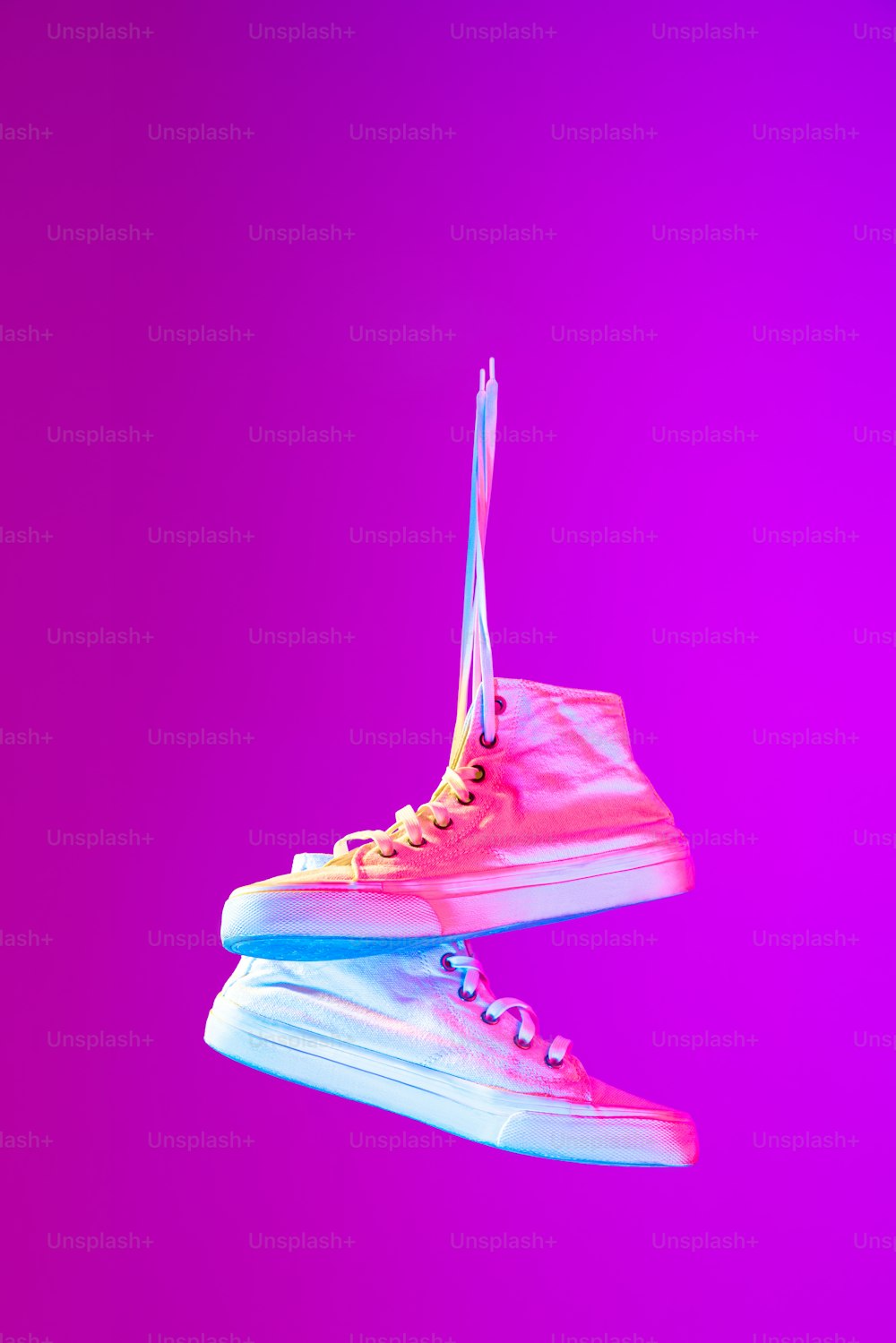 Image of fashionable sports shoes, sneakers isolated over colored neon background. Urban city fashion, fitness, sport, training concept. Copy space for ad, text, design. Mockup