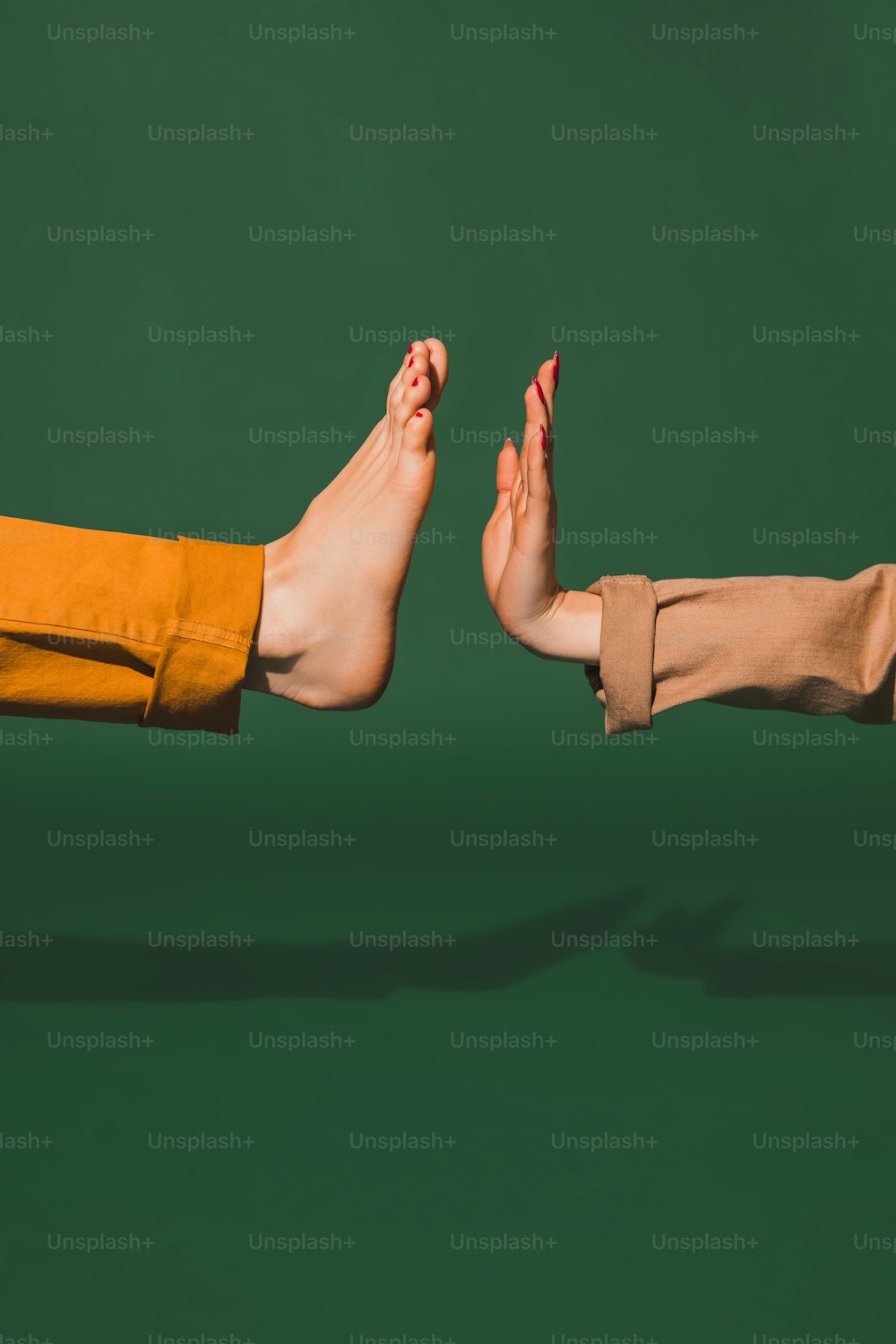 Clapping. Bright fashionable hand and leg working up daily things together. Modern artwork, contemporary art. Trendy colors, magazine style. Usual routine in unusual way. Green background.