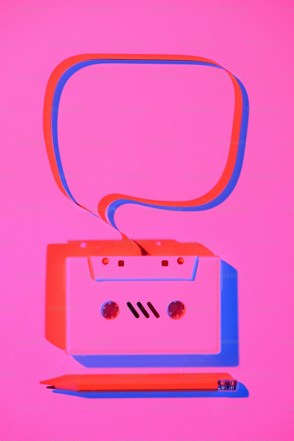 toned pink picture of pencil and retro audio cassette with speech bubble