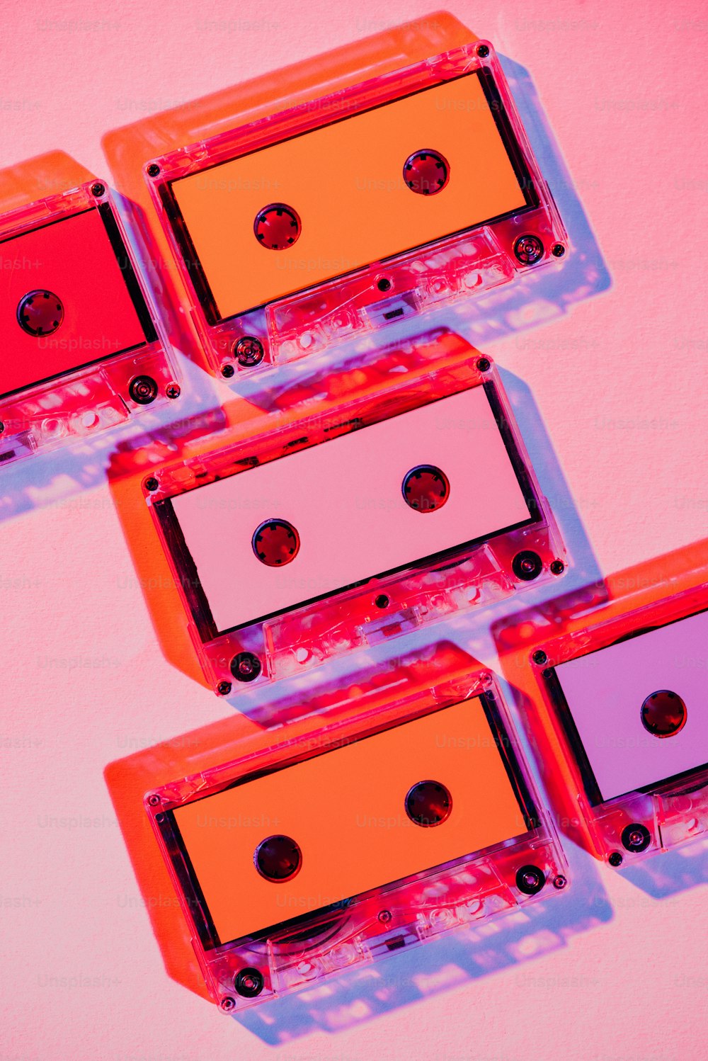 toned picture of colorful retro audio cassettes on pink background
