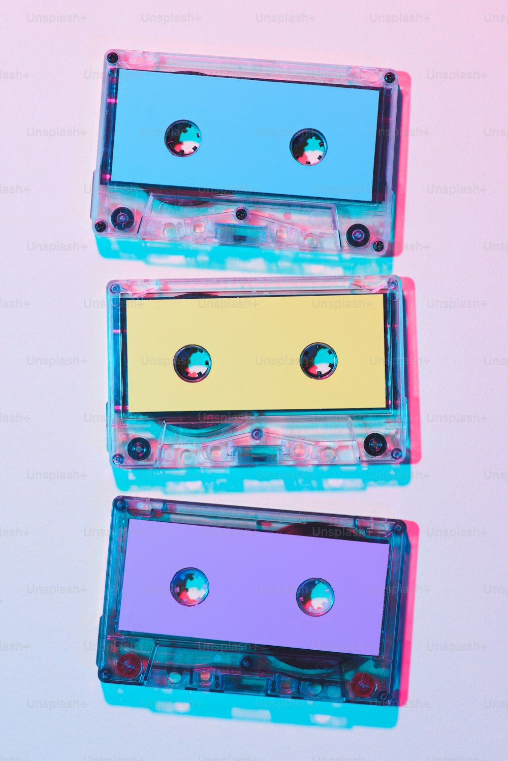 top view of arranged colorful audio cassettes on purple background