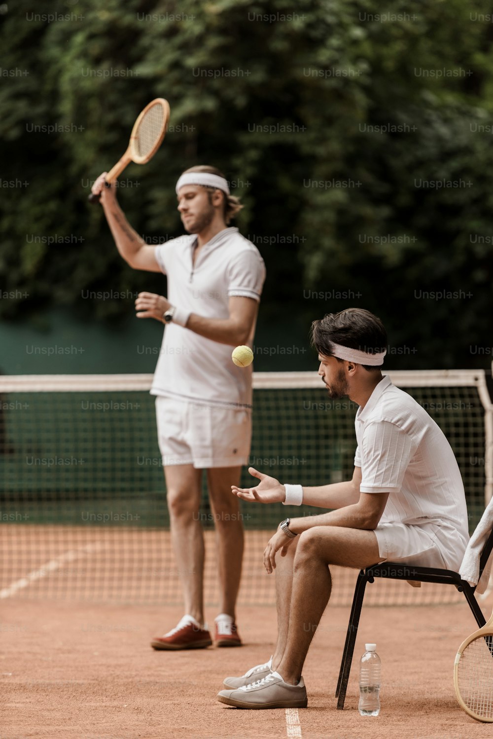 retro styled tennis players preparing for game at tennis court