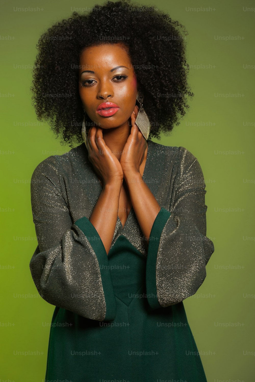 Sensual retro seventies fashion afro woman with green dress. Green background.