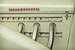 Retro styled image of the side view of a classic car with chrome exhausts