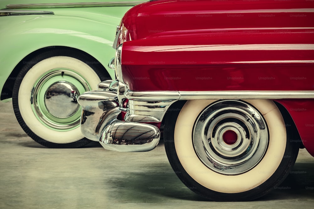 retro styled image of two vintage American cars parked next to each other