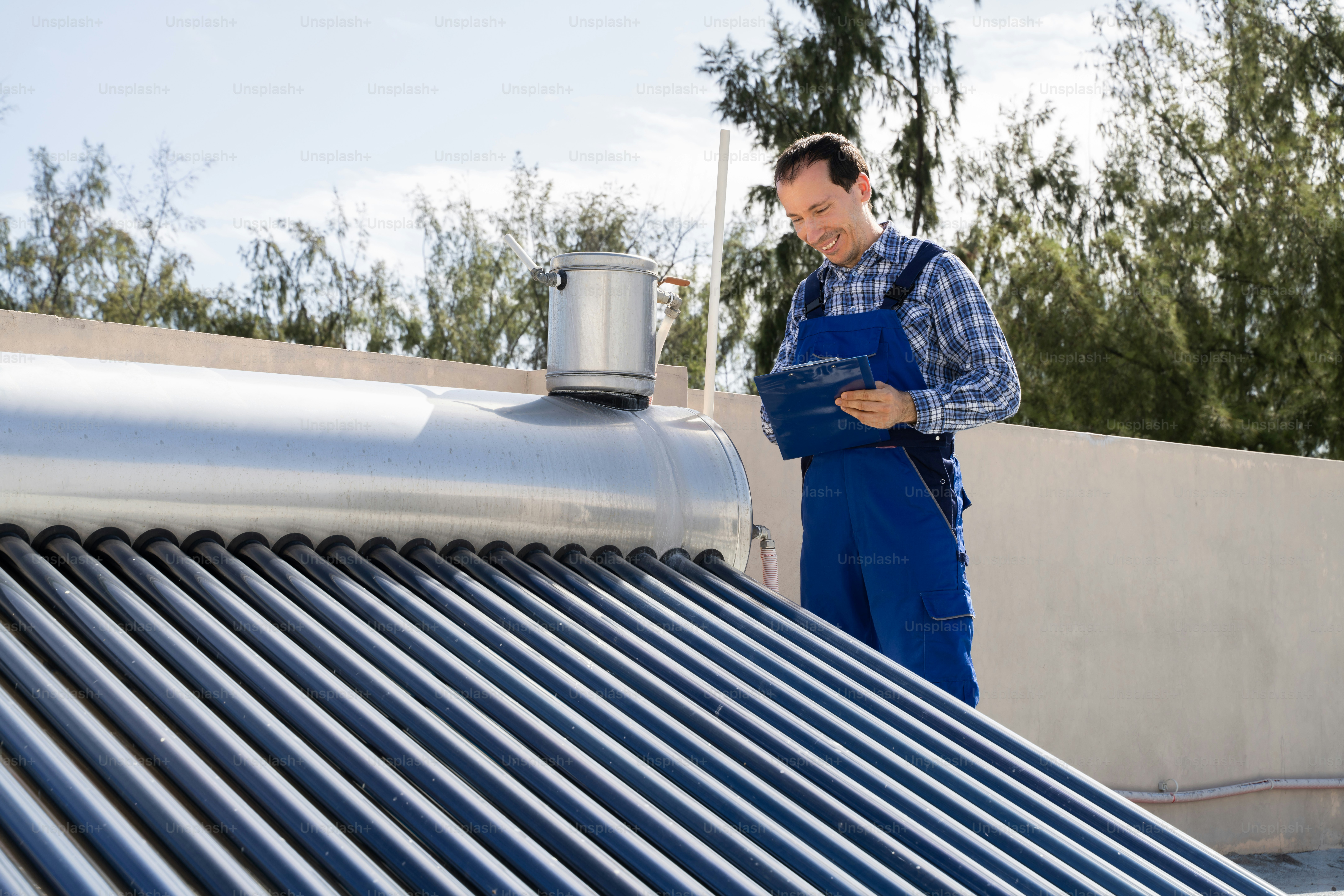 Male Plumber Doing Solar Energy Boiler Inspection