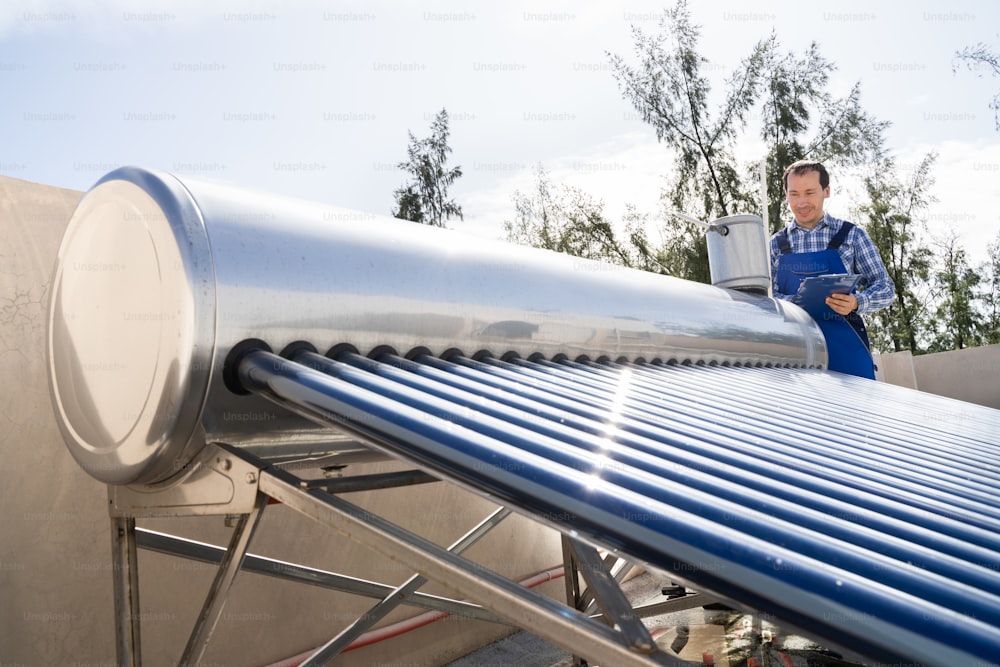 Male Plumber Doing Solar Energy Boiler Inspection