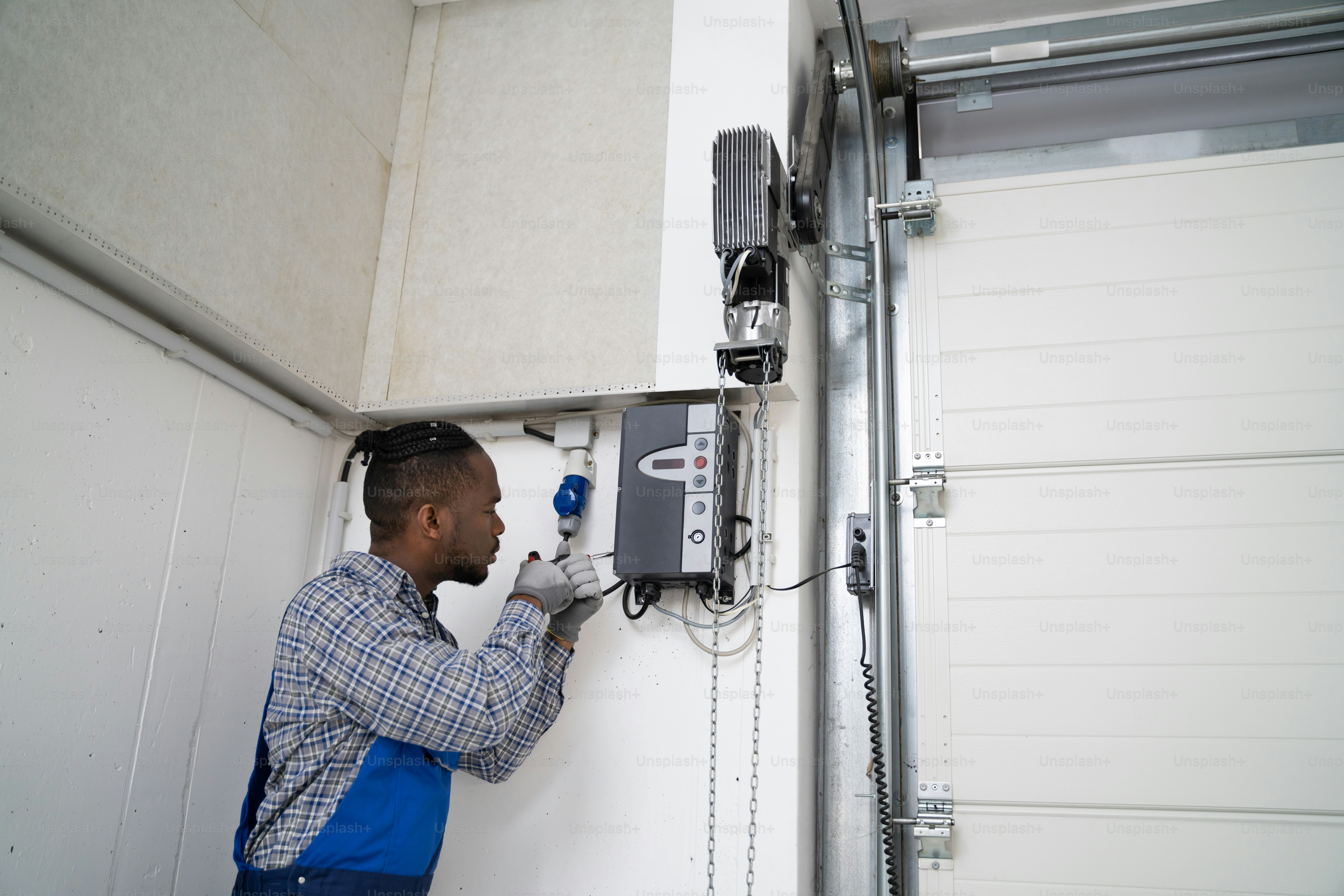 Technician configuring refrigerated shipment tracking sensors inside temperature-controlled warehouse