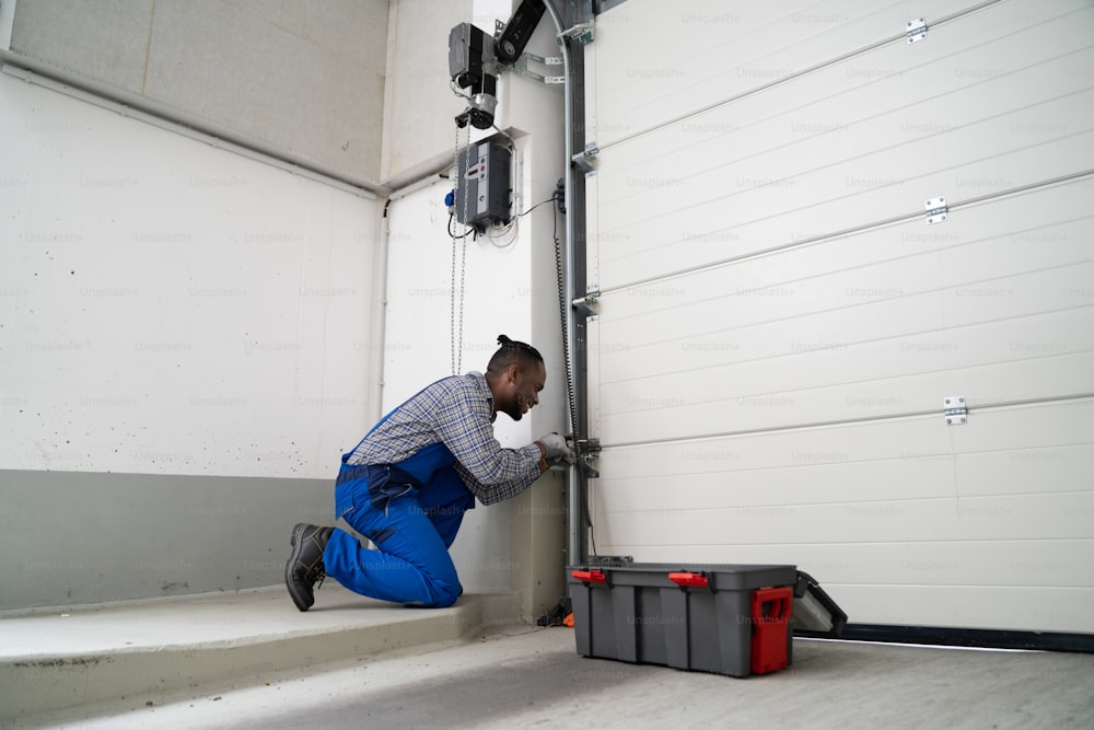 Instalação e reparação de portas de garagem em casa. Empreiteiro Homem em Casa