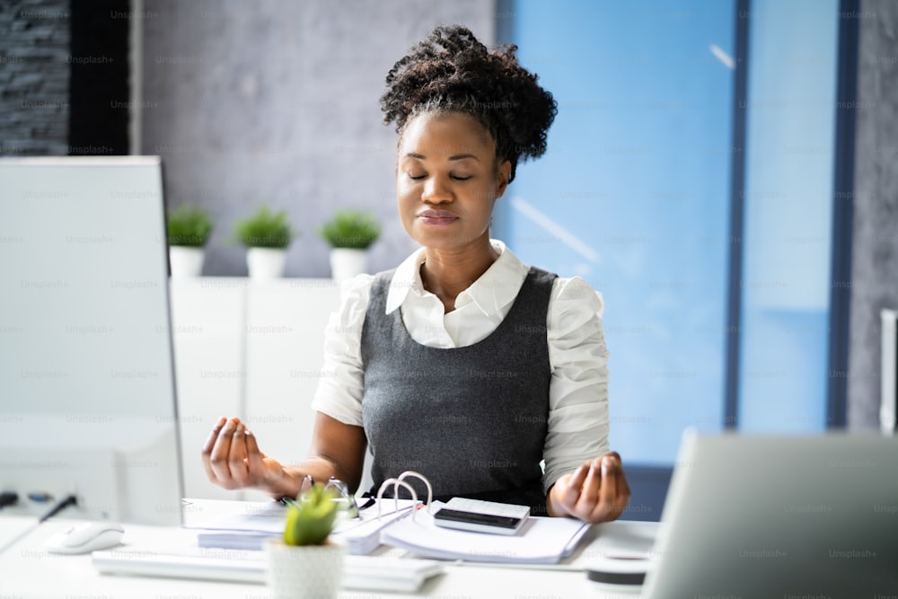Yoga Meditation At Corporate Desk. American African Businesswoman