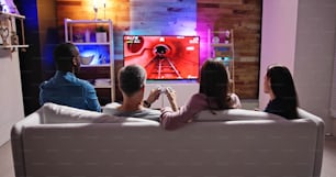 Rear View Of An People Playing Video Games At Home