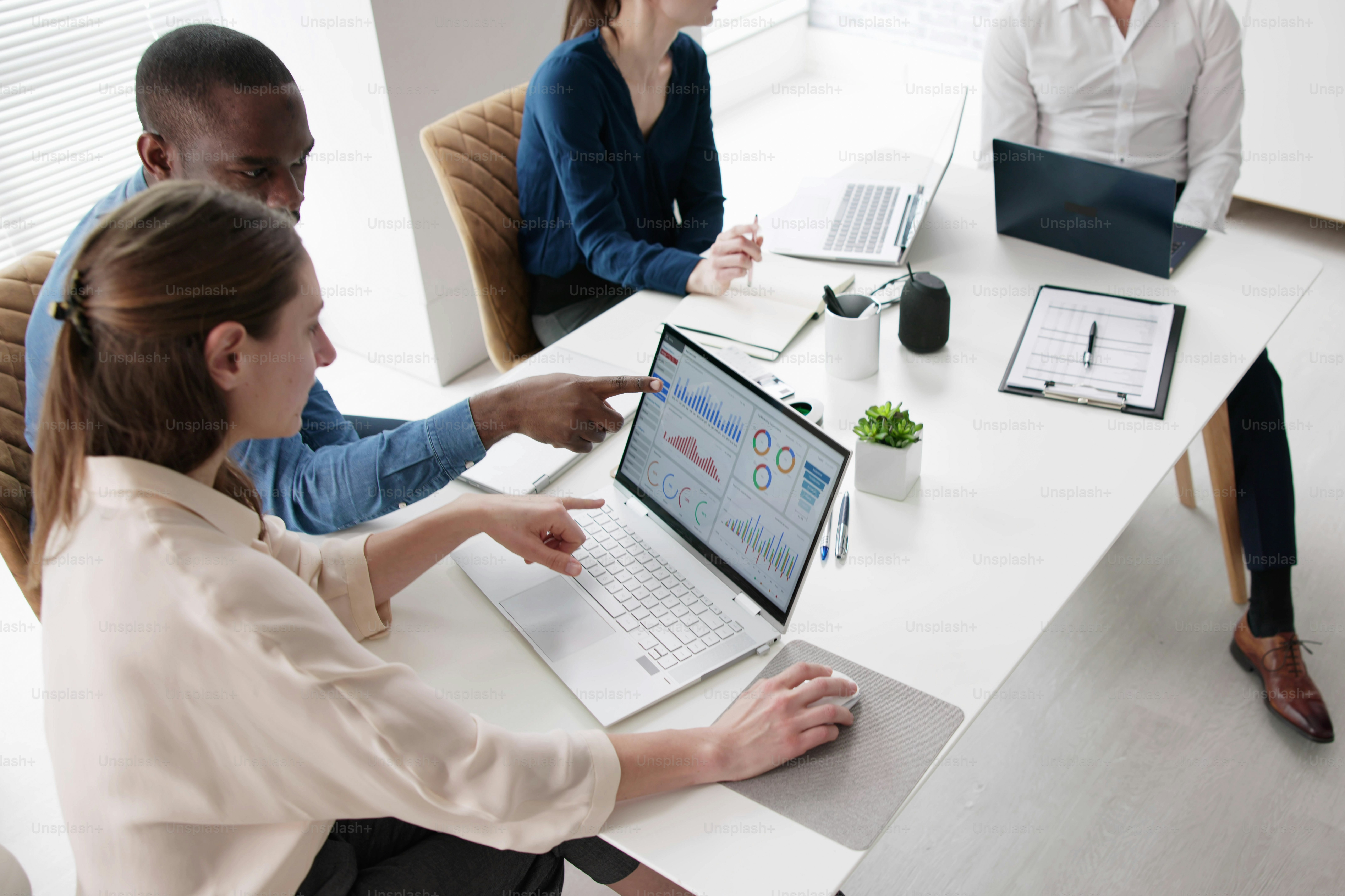 Financial advisor group meeting examining analytics dashboard photo