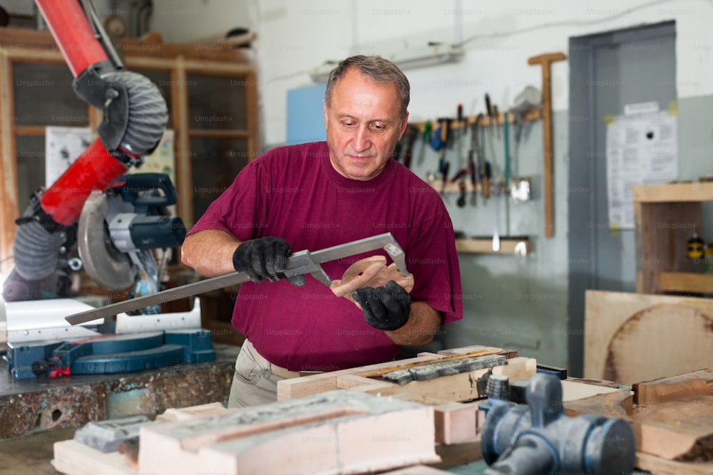 Foreman checks 3d model with a caliper