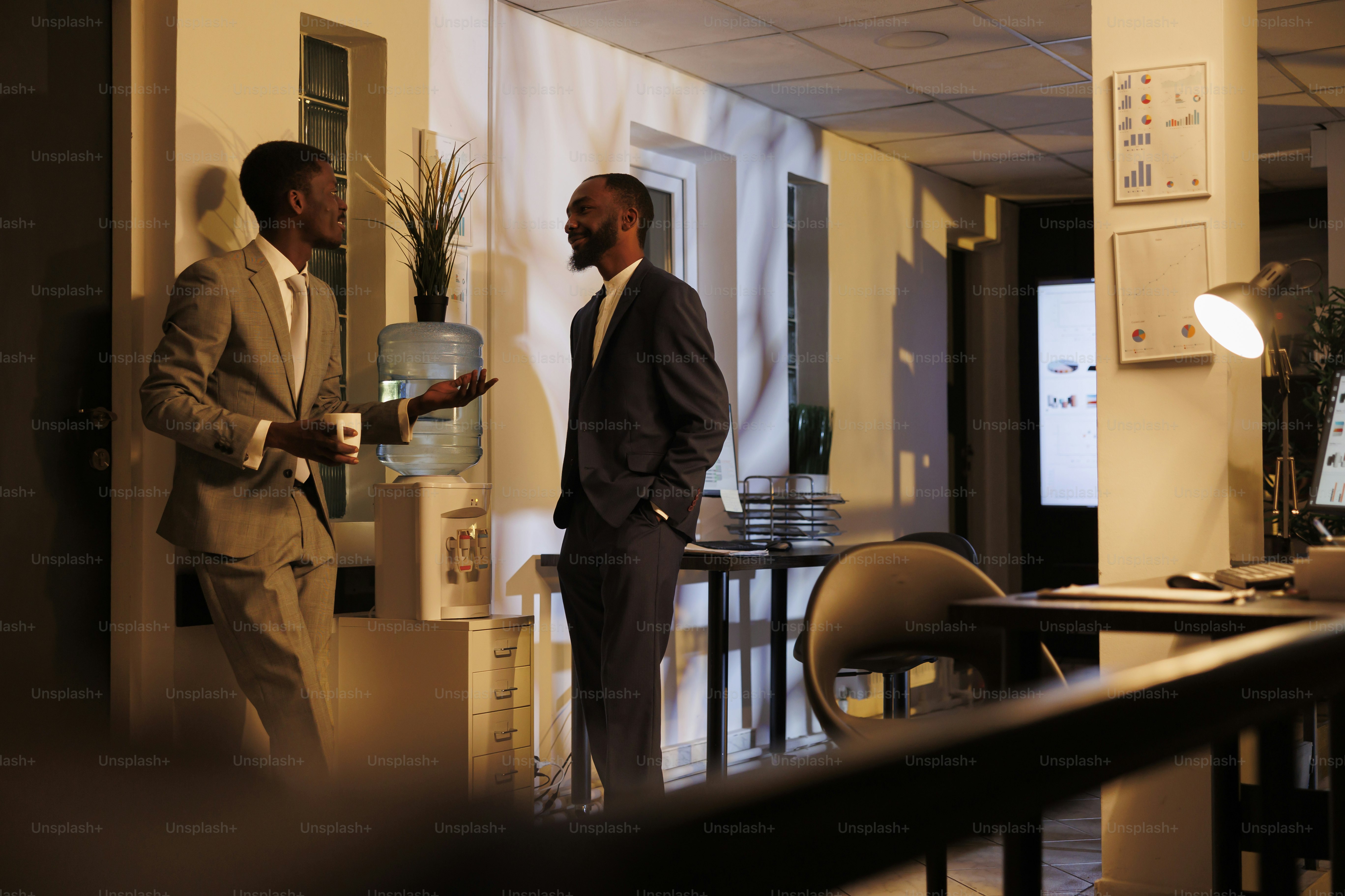 Coworkers discussing project detalies during work break, working at marketing strategy late at night in startup office. Businessmen brainstorming ideas for investment plan. Business concept