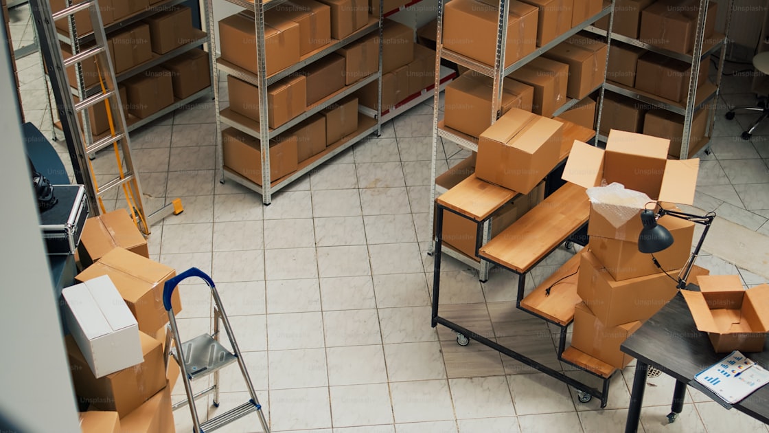 Empty warehouse aisle stacked with cardboard boxes ready for shipment of custom plush toys