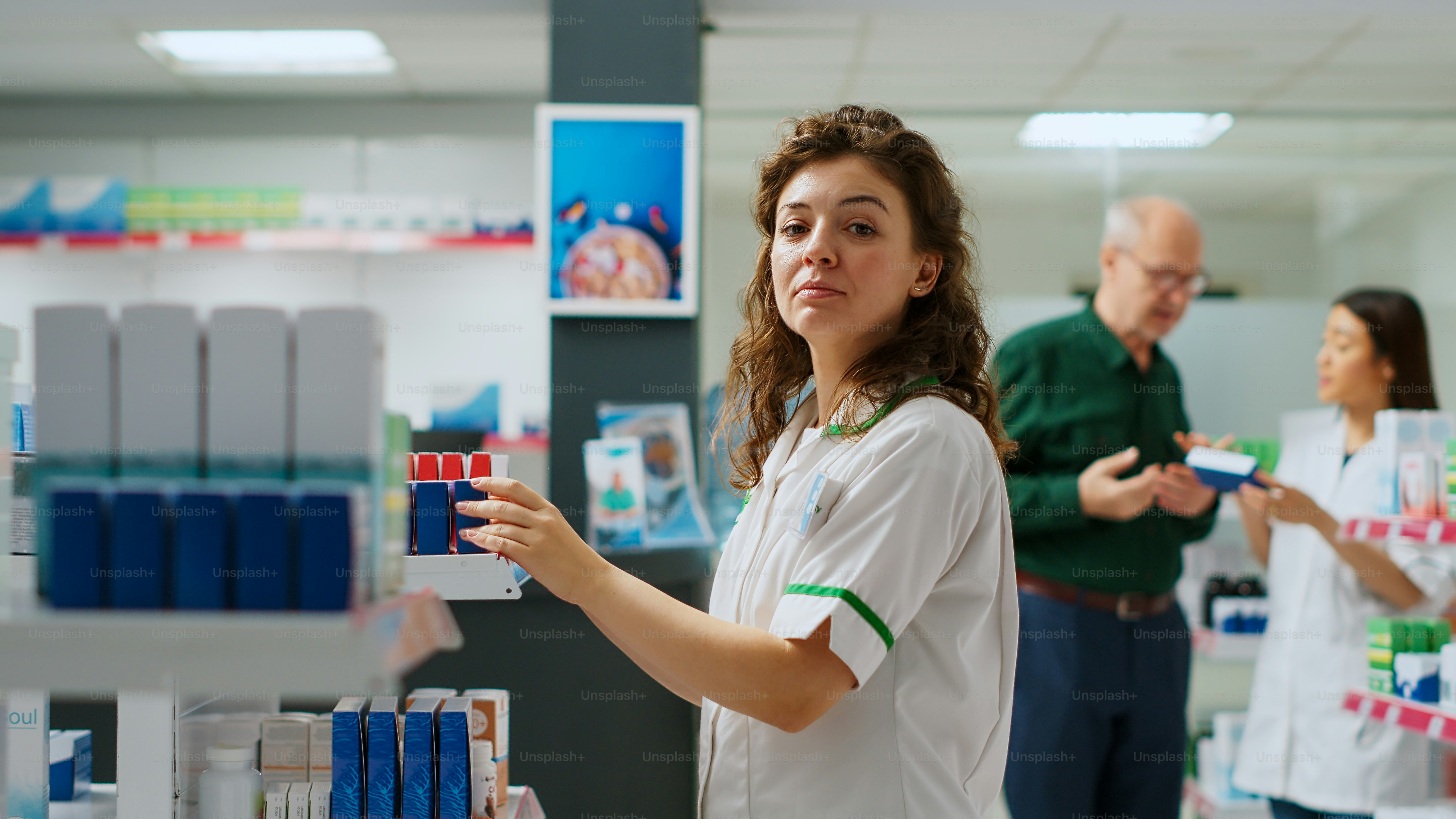 Medical worker scanning medicaments boxes at drugstore counter, helping ...