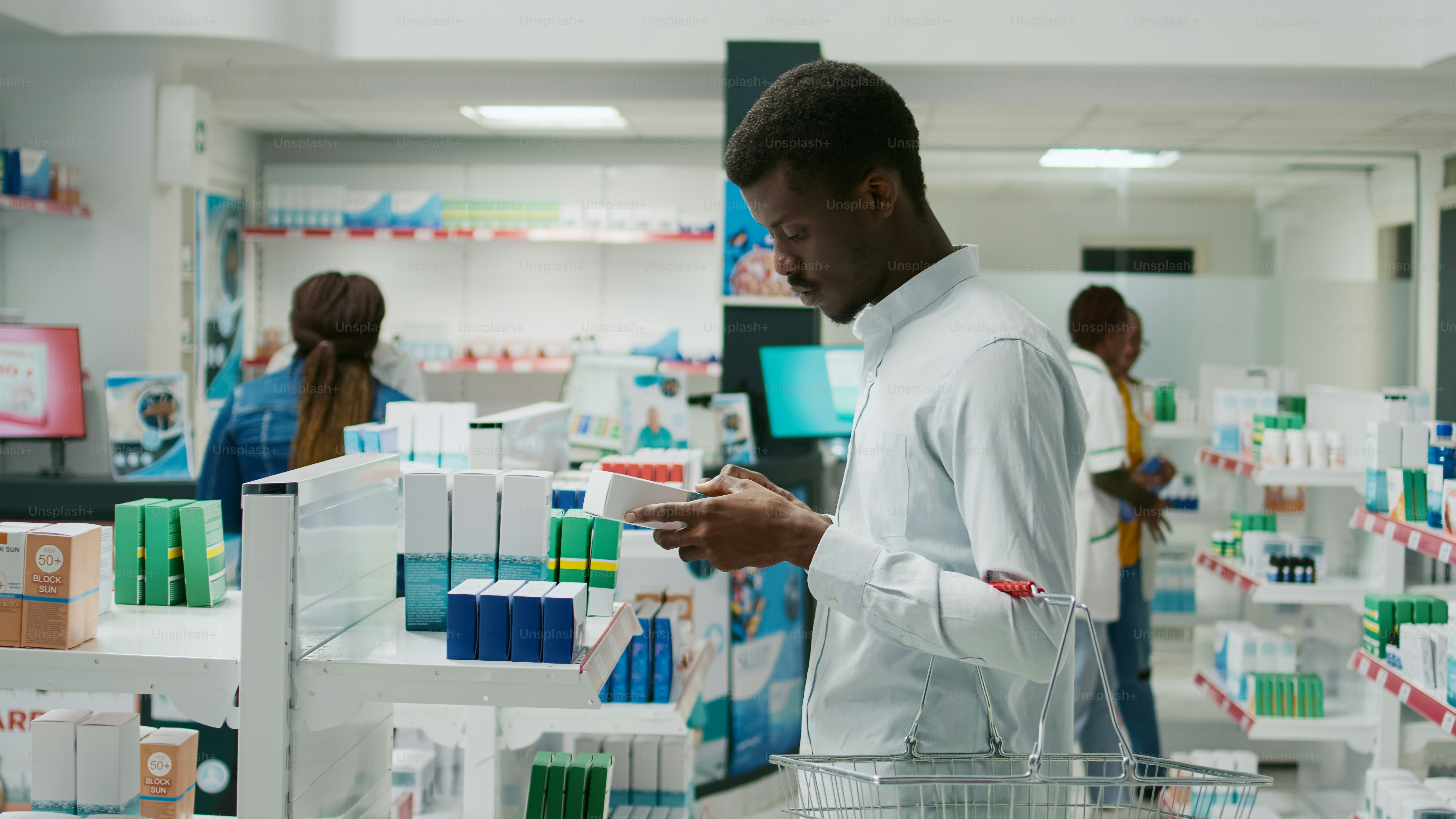 Male client reading leaflet on boxes of medicine, checking healthcare products from pharmacy. Young man looking at pharmaceutics and supplements, buying prescription treatment.