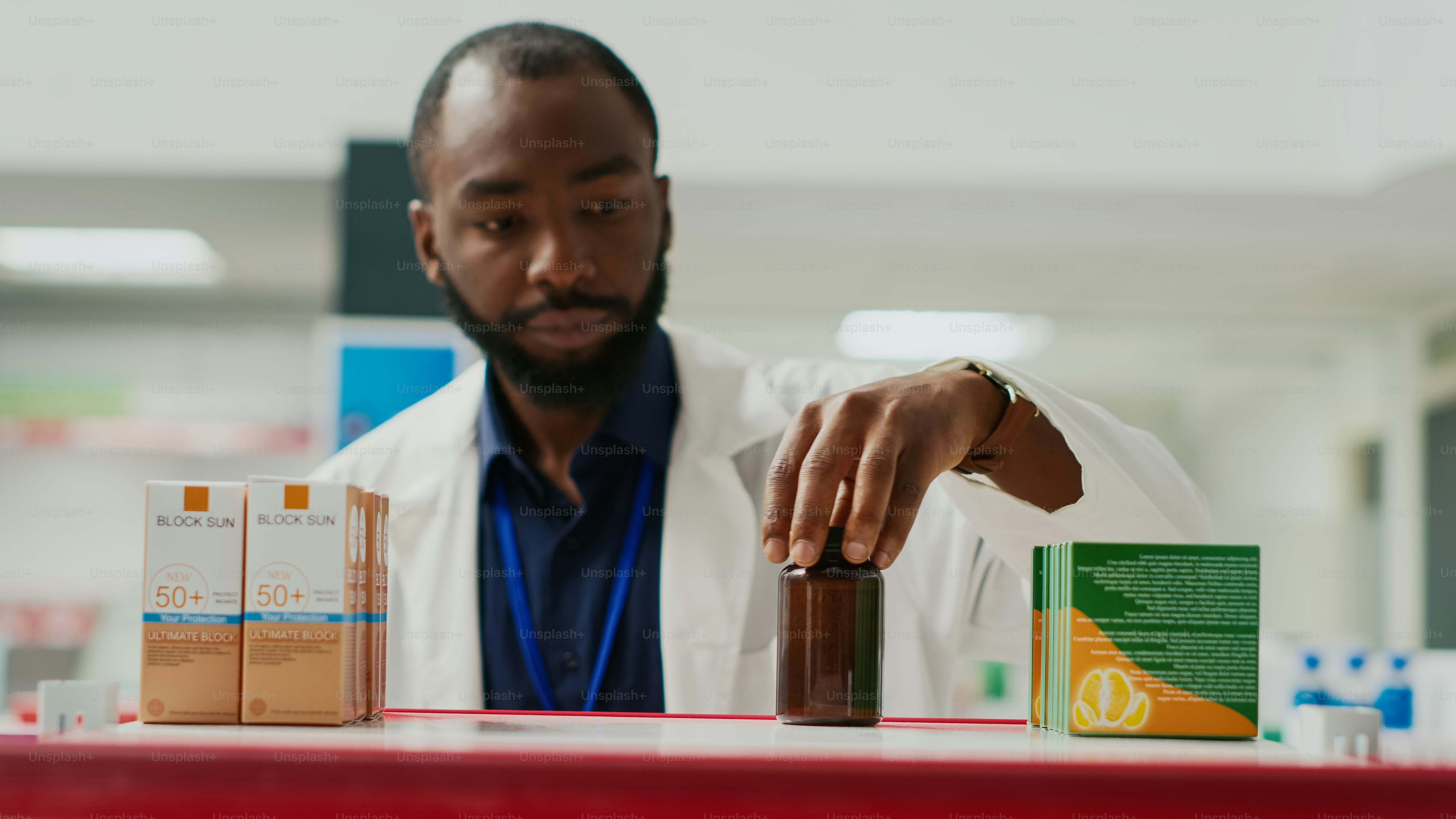 Drugstore consultant organizing drugs on racks, arranging medication and supplements. Young employee putting medicine and pills on pharmaceutical shelves, medical shop. Tripod shot. Close up.