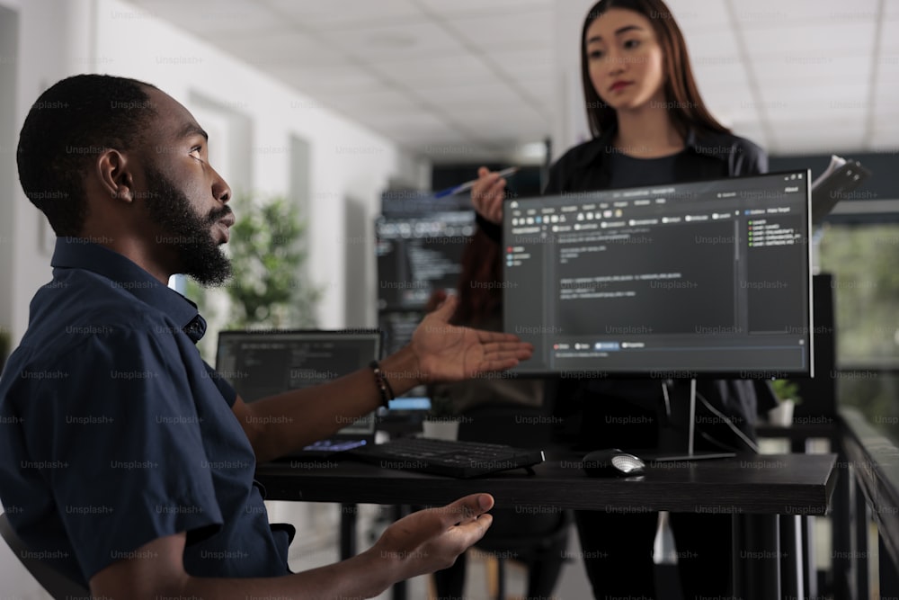 App developers working on temrinal window with html script and writing server code on computer, sitting in big data room. System engineer programming user interface in busy developing agency.