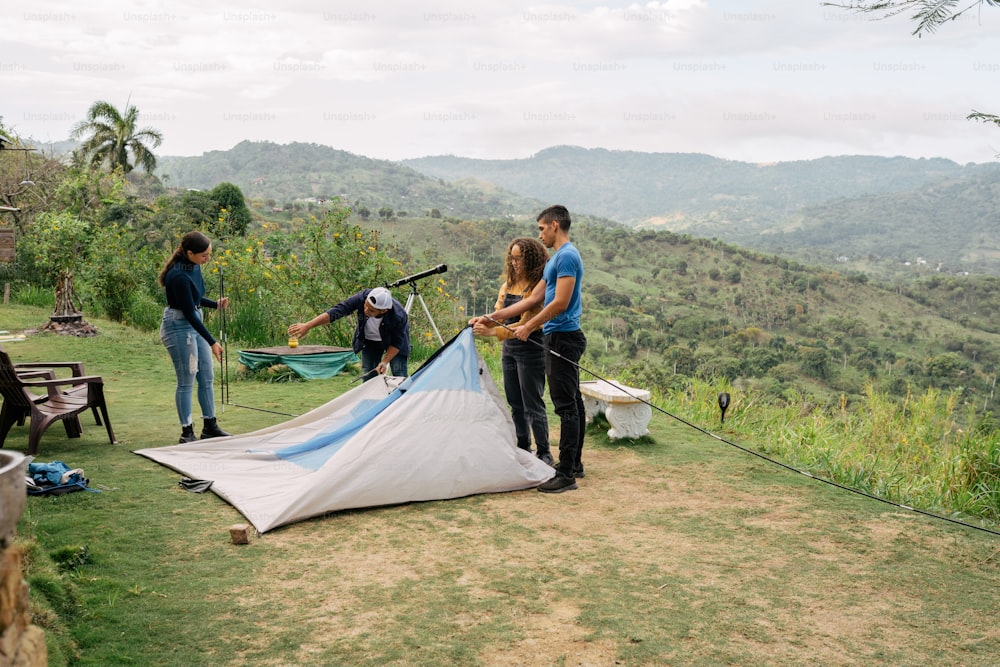 a group of people setting up a tent